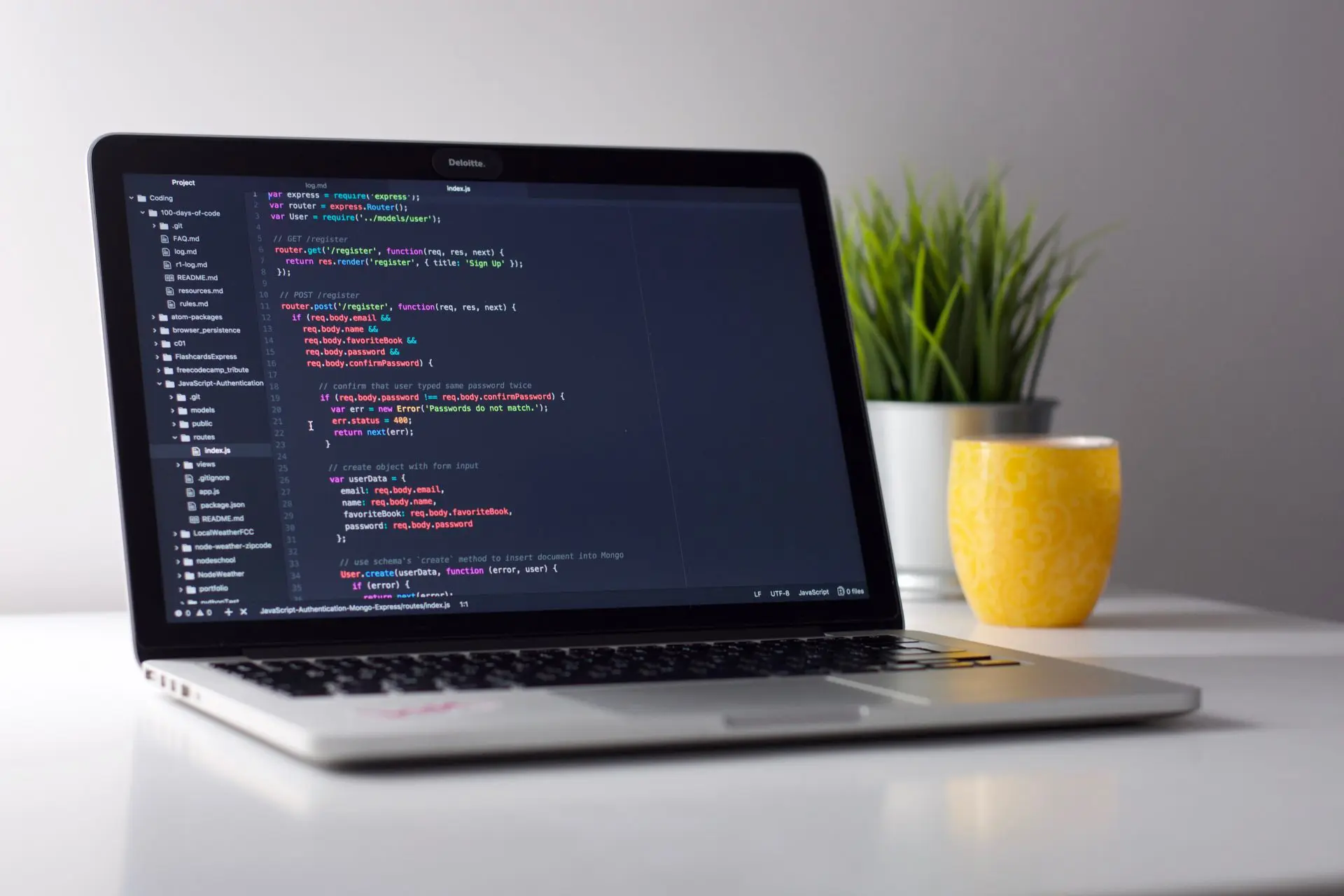 laptop with a coding screen